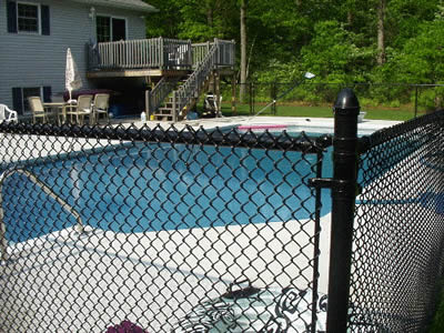 Black Chain Link Fencing protects swimming pool